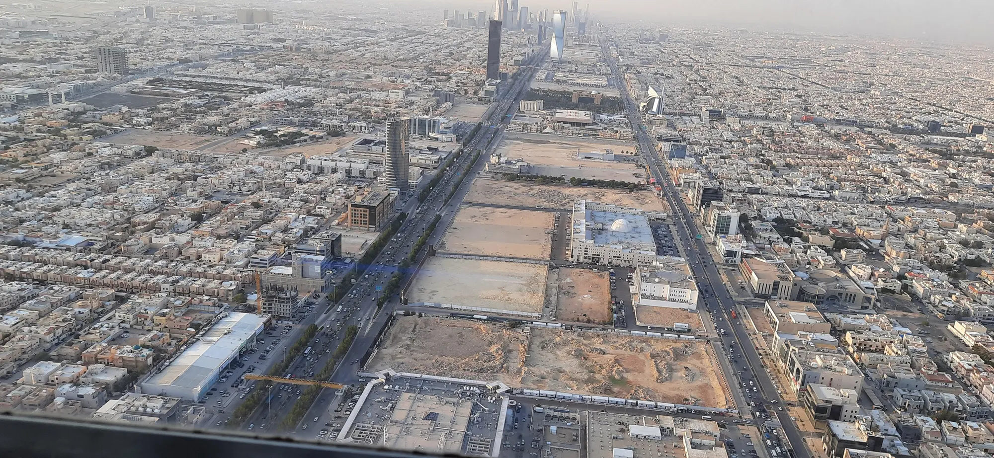 Looking down King Fahd Road from the Kingdom Centre sky bridge by day, the city running to the horizon